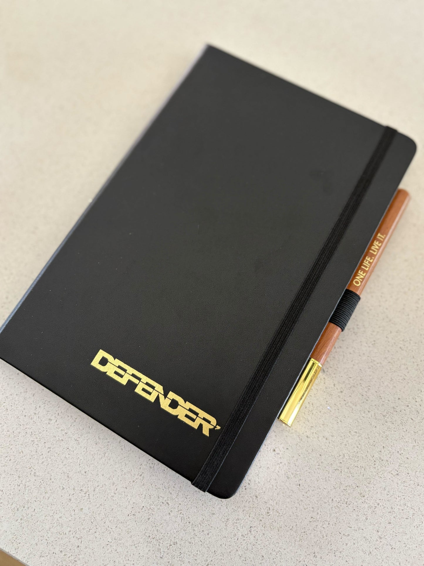 Black Notebook with Defender ext and wooden pen one life live it
